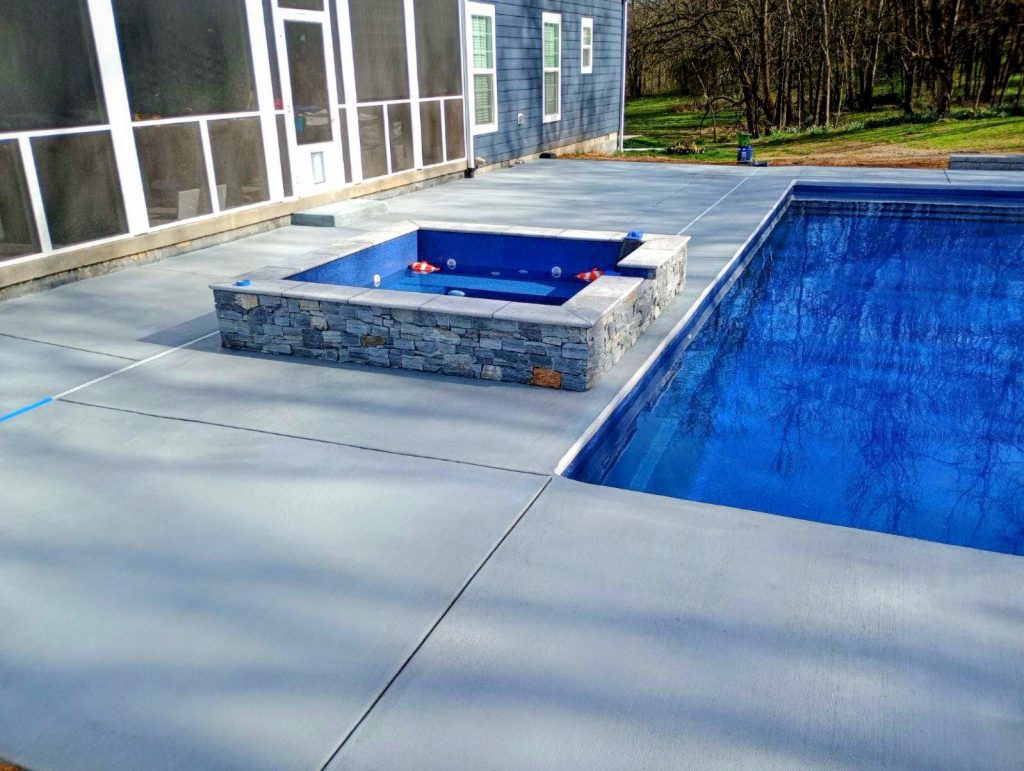 custom concrete pool deck with hot tub - The Concrete Gentlemen